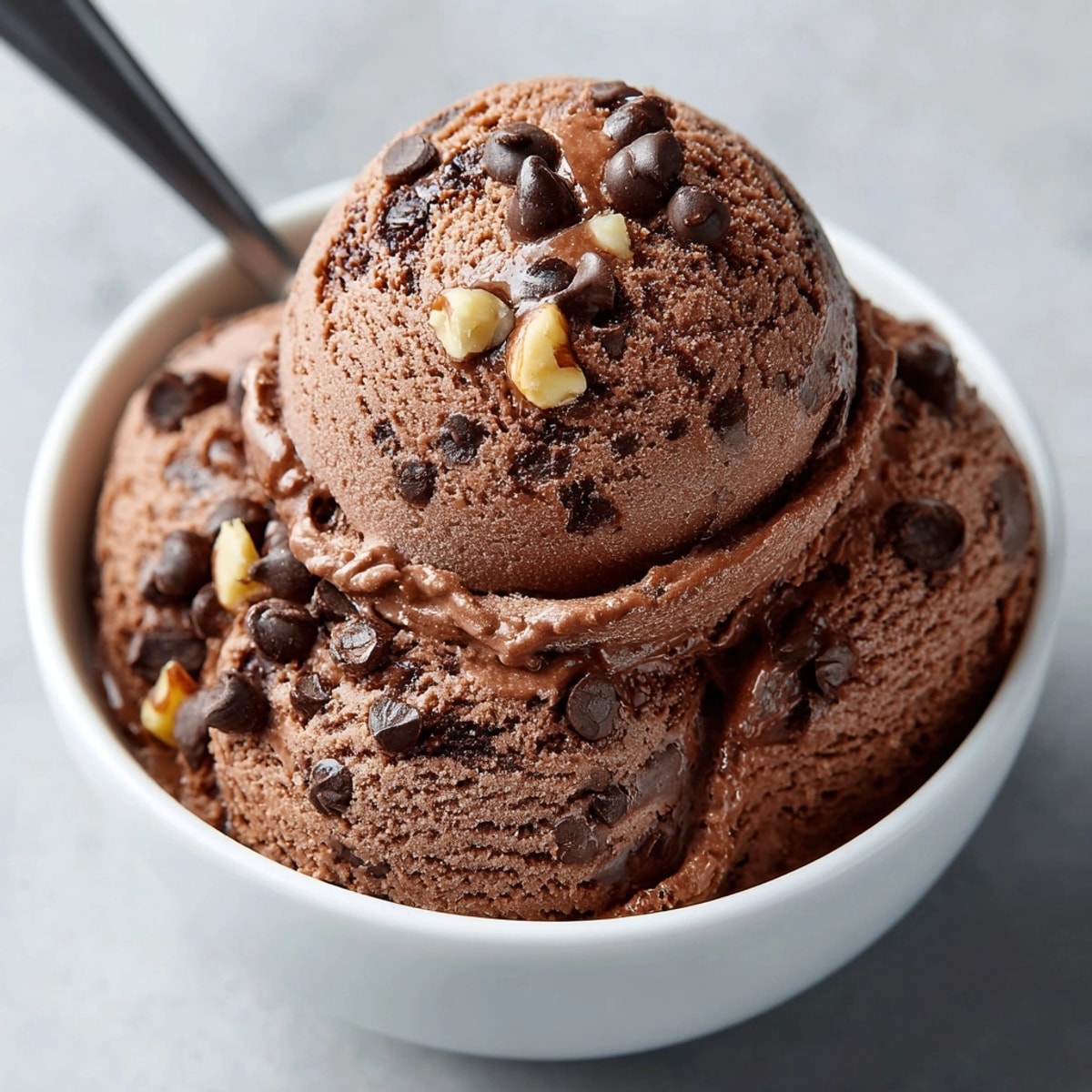 Chocolate Avocado Ice Cream scooped into a bowl, silky texture and rich chocolate aroma.