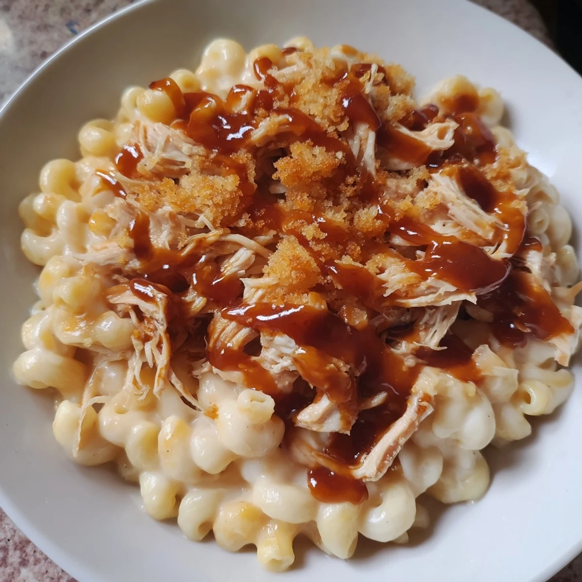 This creamy Classic Mac & Cheese with BBQ Chicken is richly topped with pulled, smoky barbecue chicken.