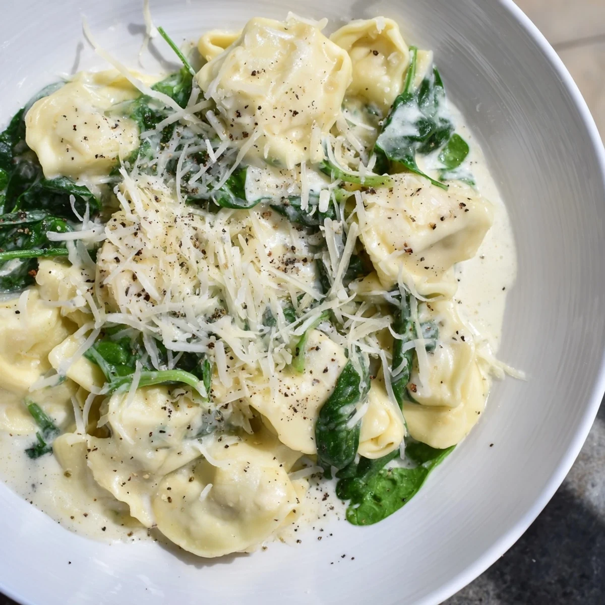 Creamy spinach Alfredo tortellini, a comforting vegetarian Italian pasta dish with a creamy sauce.