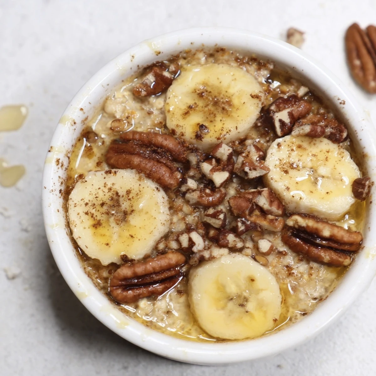 Golden-brown Baked Oats Ramekins with Banana and Honey, a warm and comforting breakfast treat.