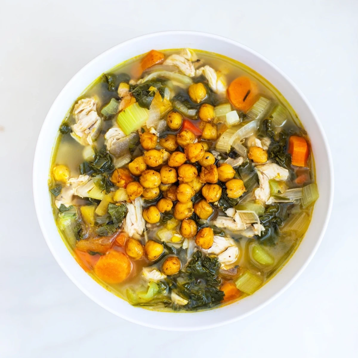 This delicious image presents a steaming bowl of Chicken Kale Soup, an easy and healthy American recipe.