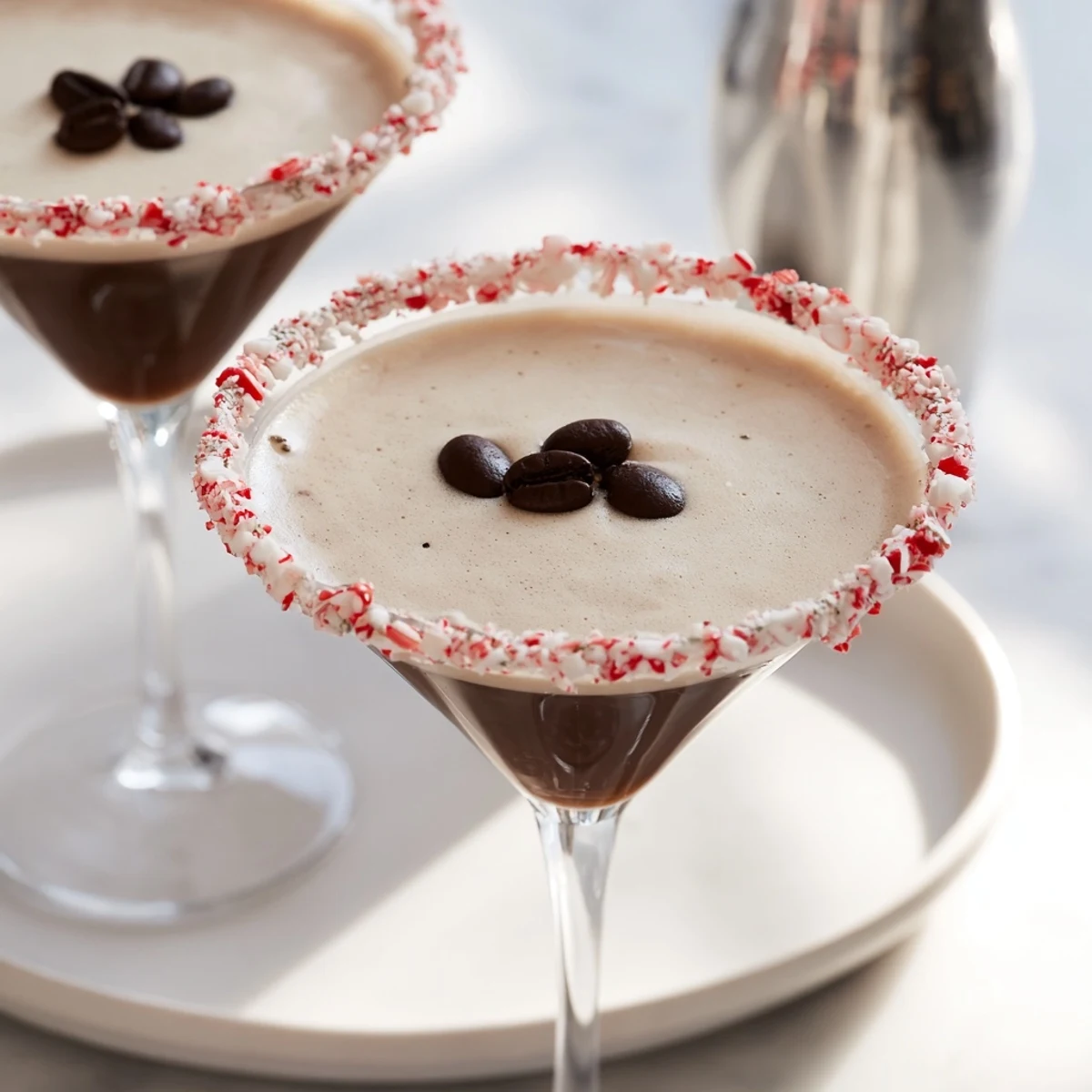 Chilled Peppermint Espresso Martini, with a crushed candy cane rim, ready for sipping.