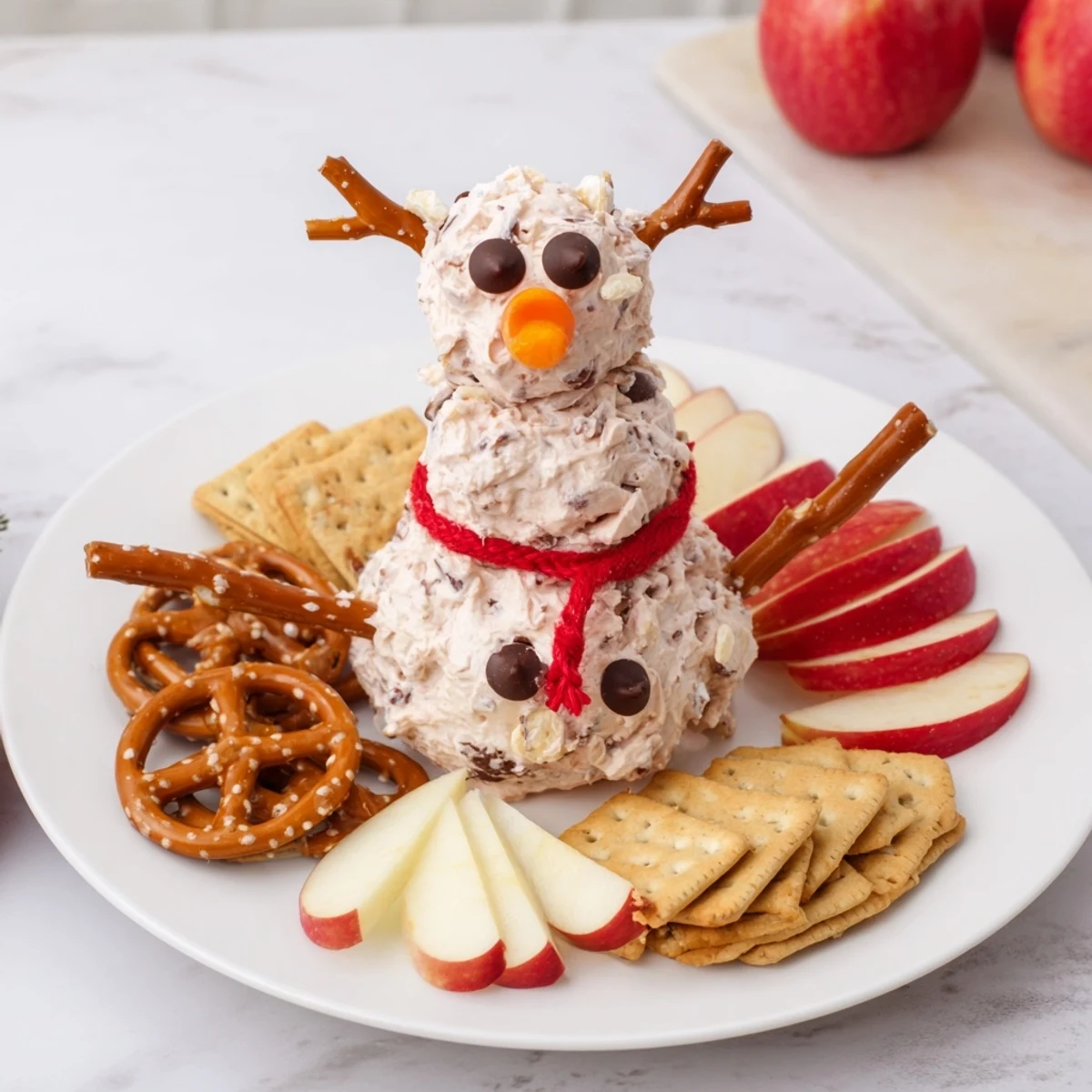 A festive Hot Cocoa Dip snowman, a creamy chocolate dessert, perfect for winter entertaining.