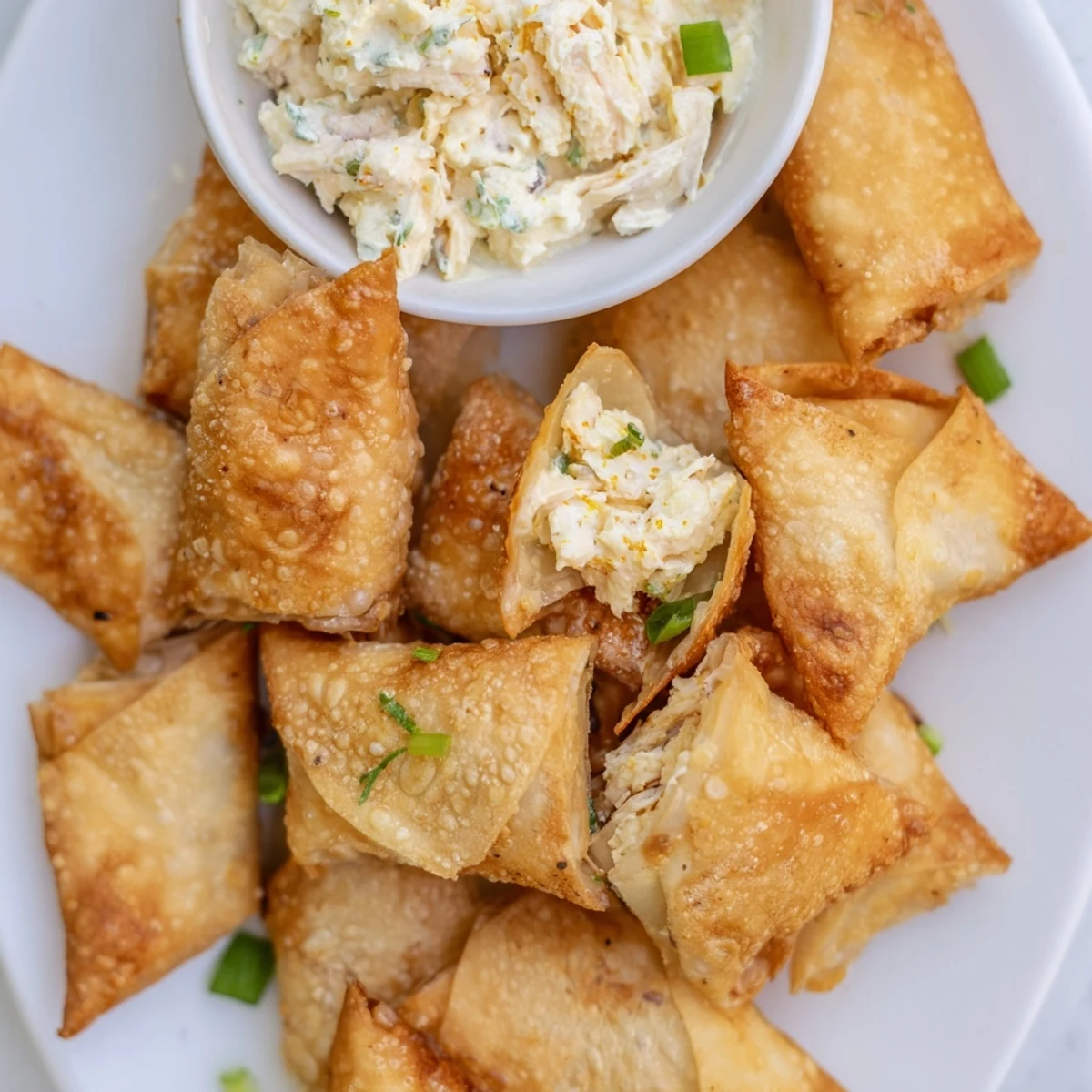 Crispy air fryer lumpia chips, perfect for scooping up the savory chicken cream cheese dip.
