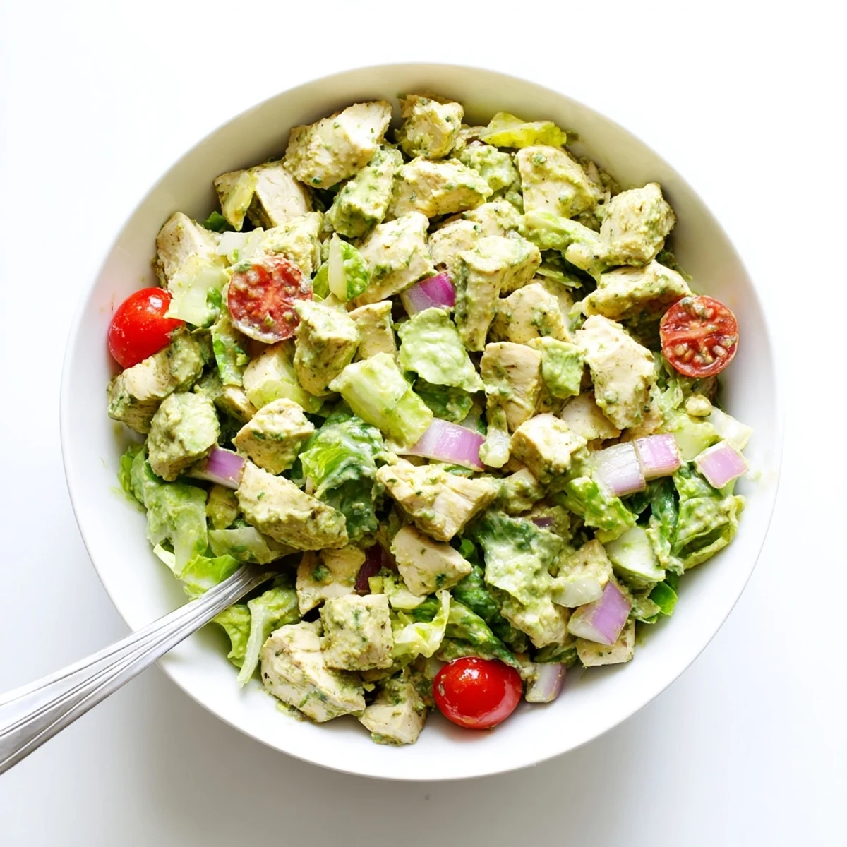 Hearty avocado ranch chicken salad served on a bed of mixed greens with juicy tomatoes and crunchy vegetables.