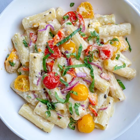 Vibrant one-pan baked feta Christmas pasta, with roasted tomatoes and creamy feta cheese, ready to serve.