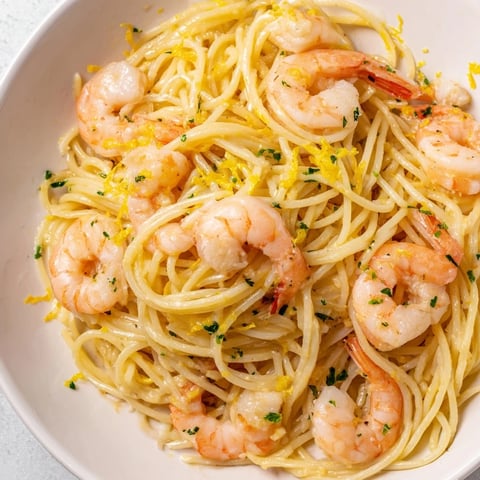 Juicy shrimp in a zesty lemon garlic butter sauce, tossed with al dente spaghetti and topped with fresh parsley.