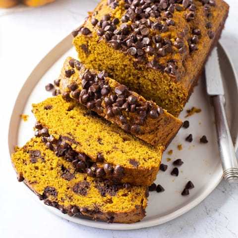 Warm, spiced Protein Pumpkin Chocolate Chip Loaf slices, ready for a healthy breakfast.