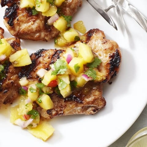 Grilled Tropical Pineapple Salsa Chicken served with coconut rice and vibrant pineapple chunks.  