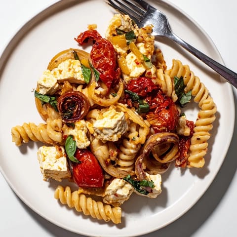 Deliciously tangy Baked Feta Pasta drizzled with olive oil and fresh basil.  
