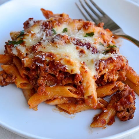 Savor the hearty layers of Cheesy Beef & Penne Bake, perfect for family meals.  