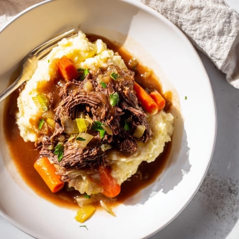 Savory slow cooker pot roast, tender beef with roasted vegetables and creamy mashed potatoes.  