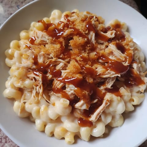 This creamy Classic Mac & Cheese with BBQ Chicken is richly topped with pulled, smoky barbecue chicken.