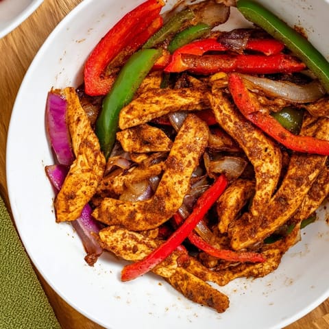 Tender chicken and vibrant vegetables, seasoned beautifully, make these sheet-pan chicken fajitas amazing.