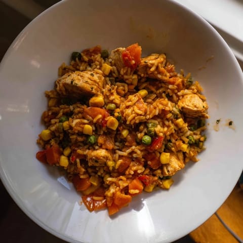 Appetizing photo of One-Pot Chicken and Rice, a budget-friendly meal with chicken, veggies, and perfectly cooked rice.