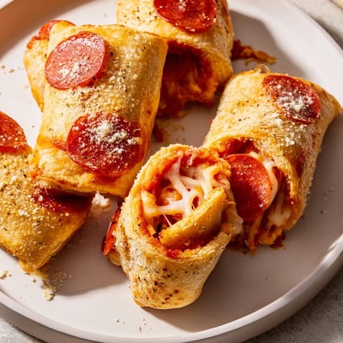 Crispy homemade air fryer pizza rolls, oozing with cheese, served with warm dipping sauce.