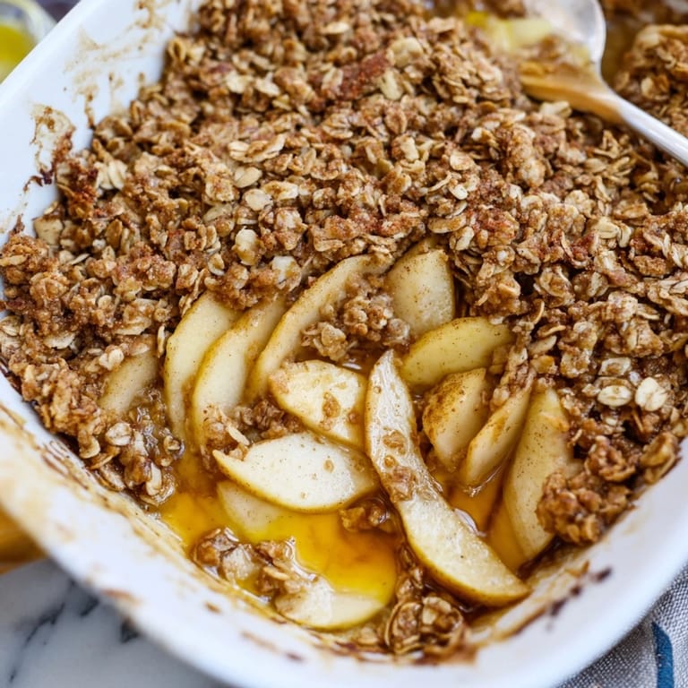 Indulge in homemade Express Apple Cinnamon Crisp served warm with creamy vanilla ice cream.