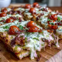 Kentucky Derby Hot Brown flatbread pizza with turkey, bacon, and creamy Mornay sauce, baked until bubbly and golden.